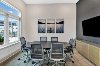 a conference room with a table and chairs at Anthem Luxury Apartment Homes and Rentals in Huntsville, AL